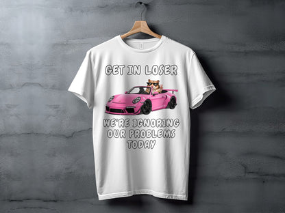 White t-shirt with graphic of cat in sunglasses driving pink sports car and text.