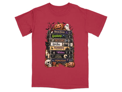 T-shirt graphic of stacked VHS tapes featuring Hocus Pocus, Goosebumps, Beetlejuice, Addams Family, and Halloween Town.