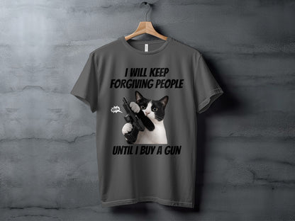 Gray t-shirt with a black and white cat holding a gun and text that reads "I WILL KEEP FORGIVING PEOPLE UNTIL I BUY A GUN".
