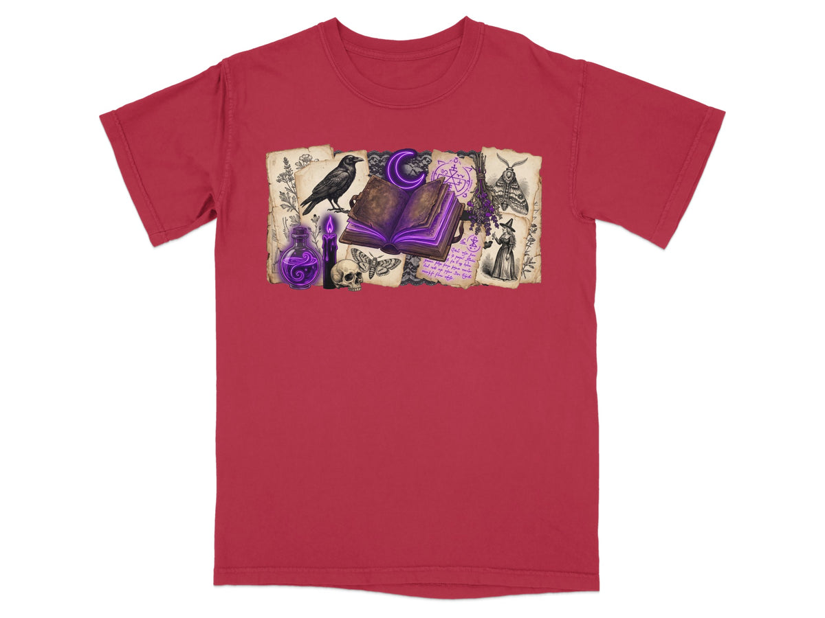 Witchy graphic on red t-shirt: open book, crow, skull, moths, potion, and witch.