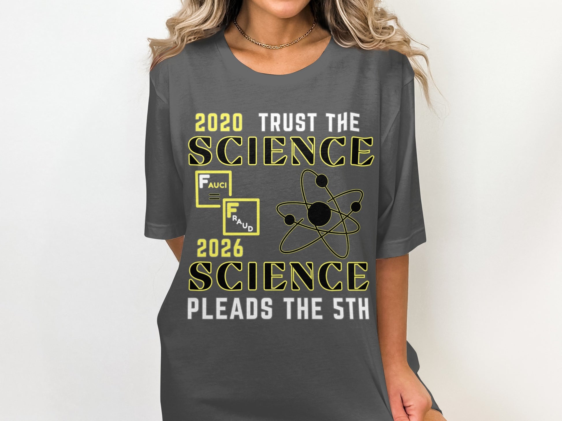 Dark gray t-shirt with text "2020 TRUST THE SCIENCE" and "2026 SCIENCE PLEADS THE 5TH".