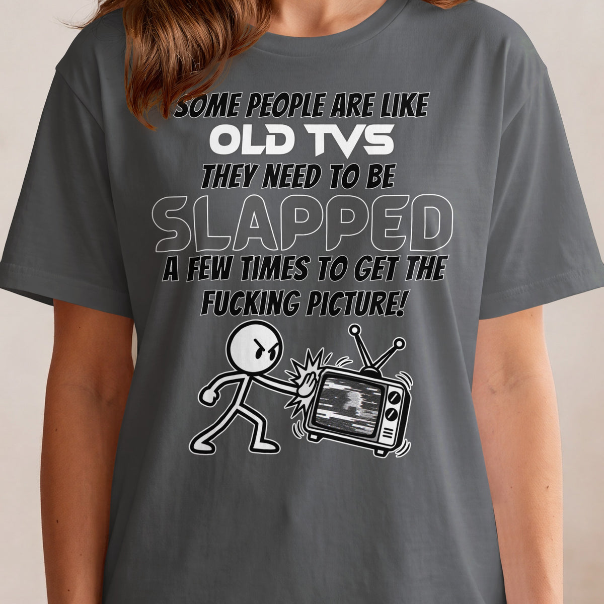 T-shirt graphic with text about slapping old TVs and a cartoon character hitting a TV.
