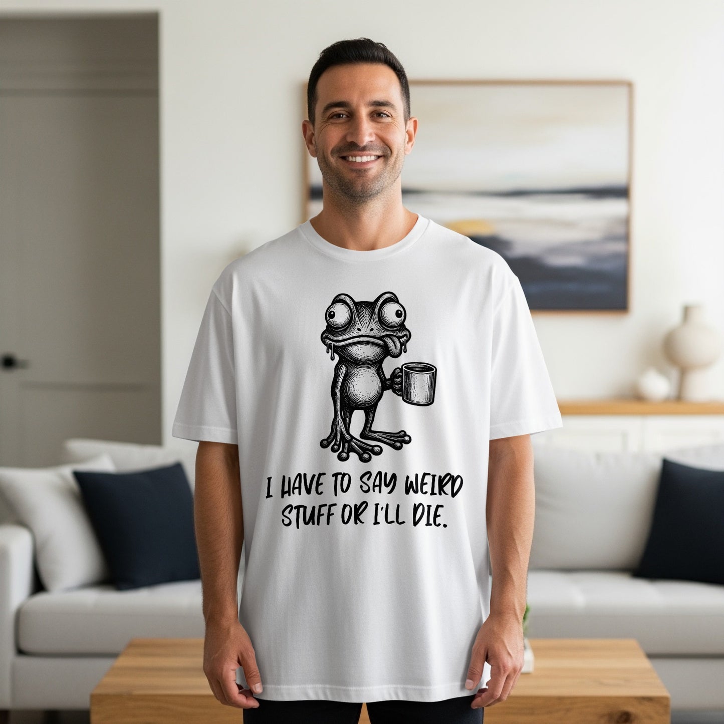 White t-shirt with a black graphic of a frog holding a coffee cup and text.