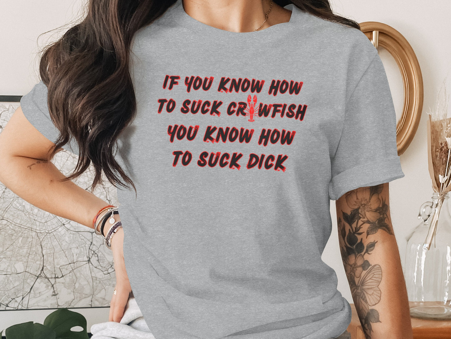 Grey t-shirt with red text "IF YOU KNOW HOW TO SUCK CRAWFISH YOU KNOW HOW TO SUCK DICK."