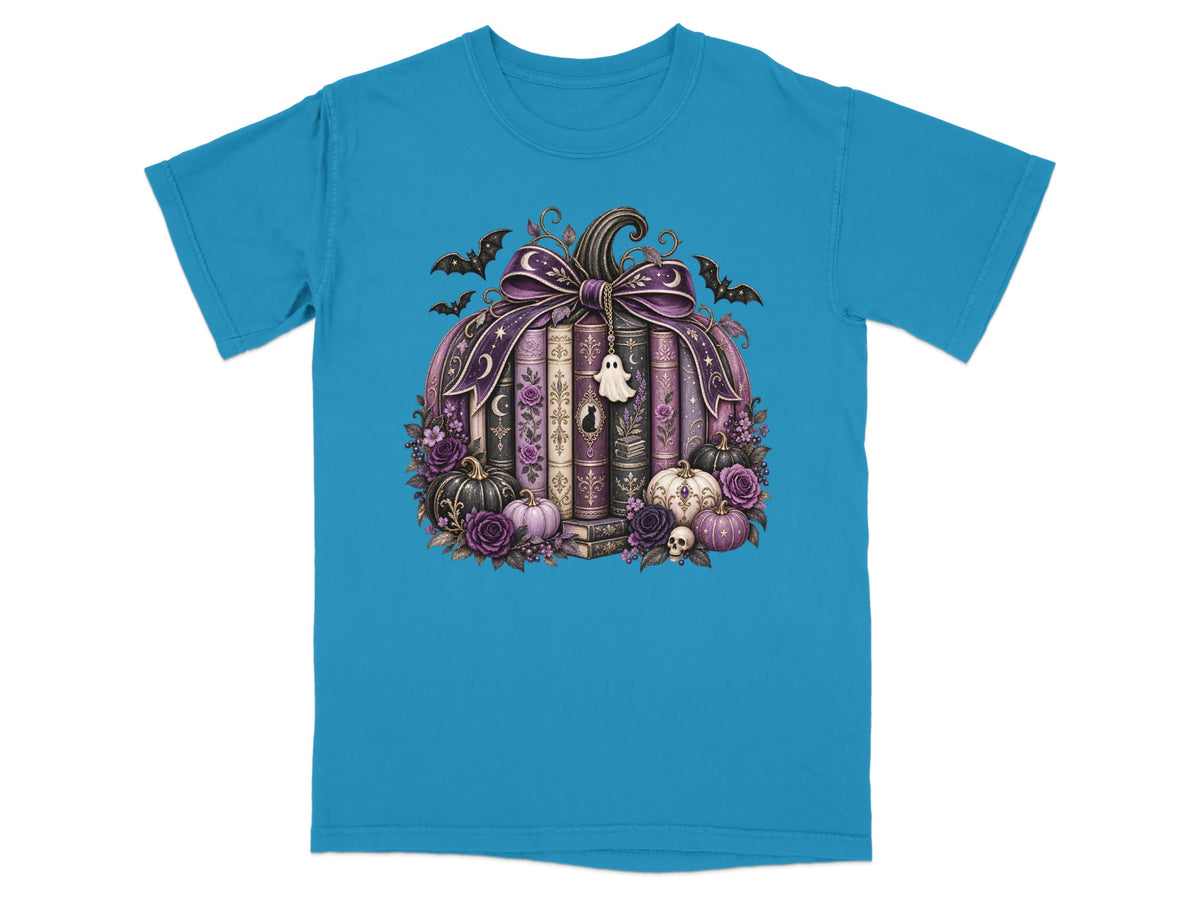 Pumpkin with books, bats, roses, and a ghost charm on a teal t-shirt.