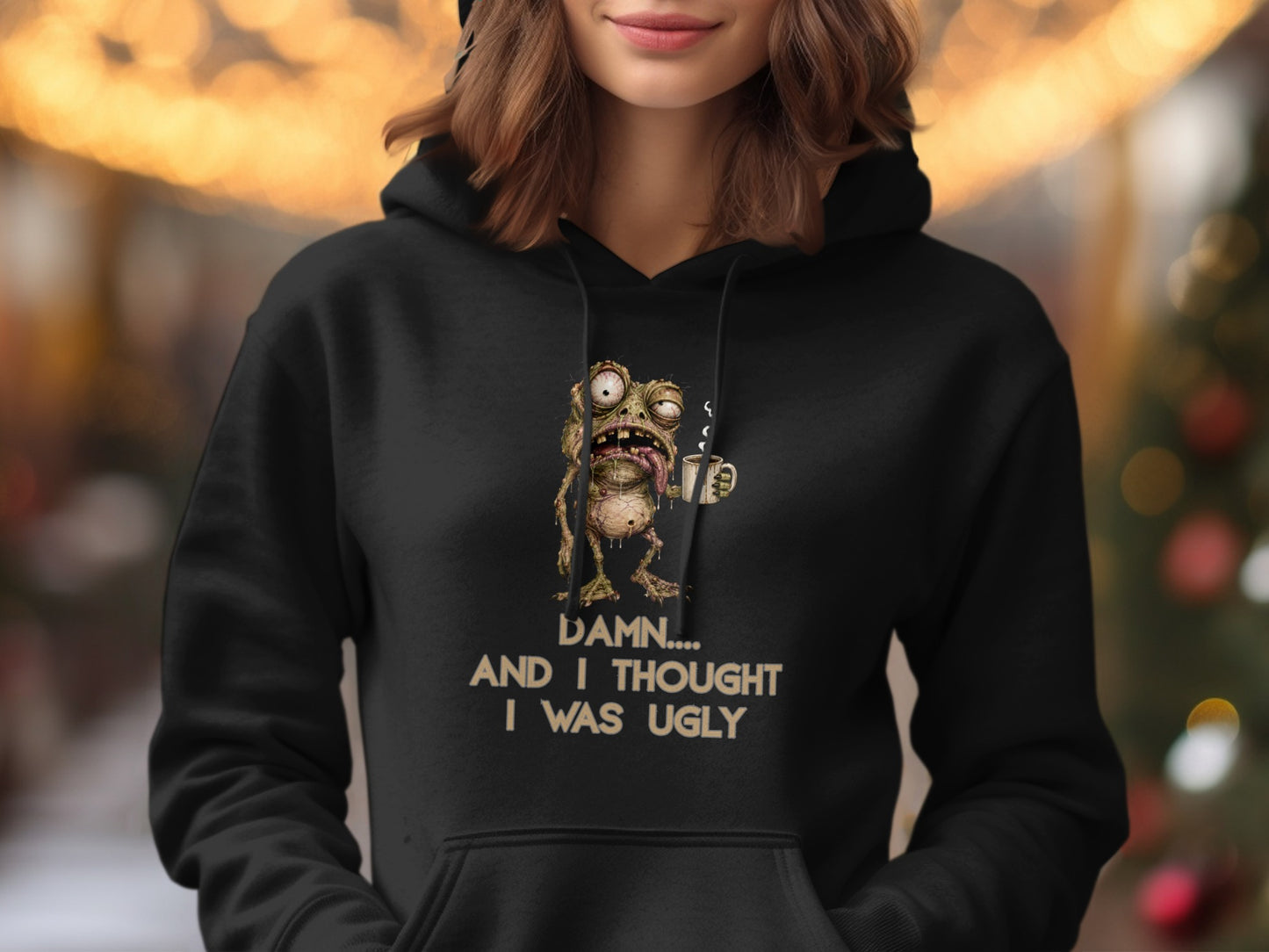 Black hoodie with graphic of a grotesque frog holding a coffee cup and text.