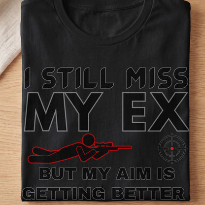 Black t-shirt with text "I STILL MISS MY EX BUT MY AIM IS GETTING BETTER".