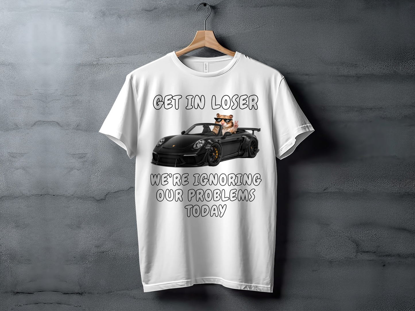 White t-shirt with graphic of hamster driving a black convertible with text "Get in loser, we're ignoring our problems today".