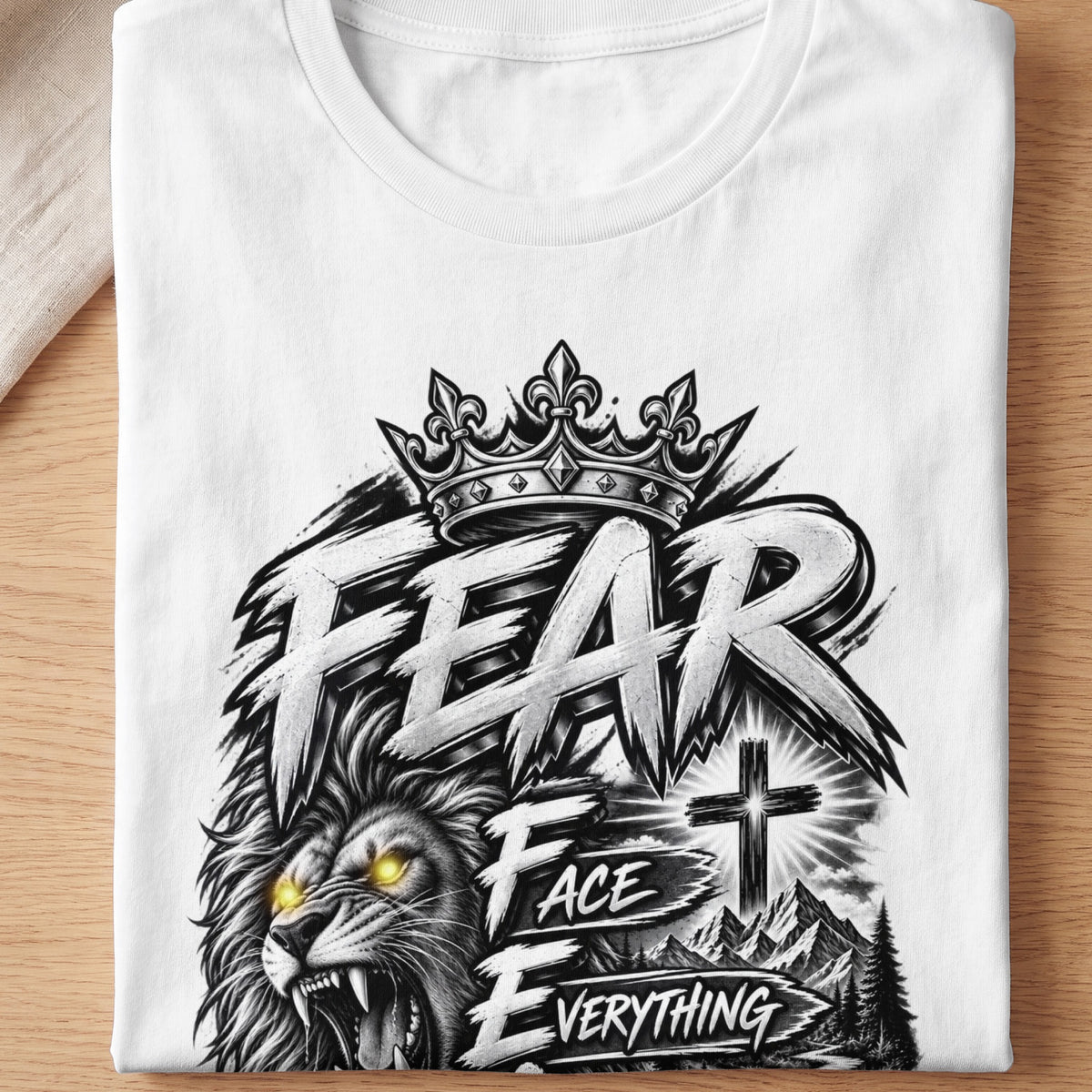 White t-shirt with a graphic of a lion's head, crown, and the words "FEAR FACE EVERYTHING".