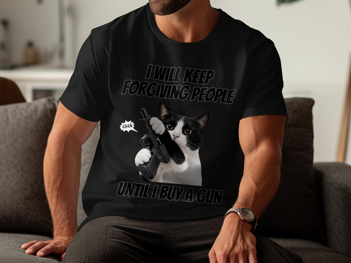 Black t-shirt with a cat holding a gun and text "I will keep forgiving people until I buy a gun."