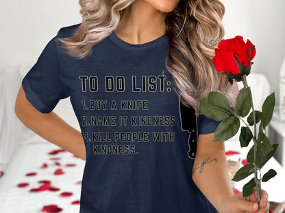 Navy t-shirt with "TO DO LIST: 1. BUY A KNIFE 2. NAME IT KINDNESS 3. KILL PEOPLE WITH KINDNESS."