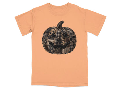 Orange t-shirt with a black patchwork jack-o'-lantern graphic.