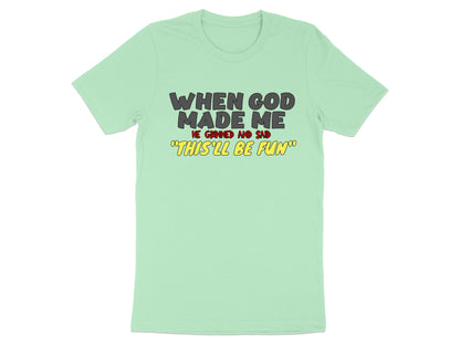 Light green t-shirt with text "When God Made Me He Grinned And Said 'This'll Be Fun'".