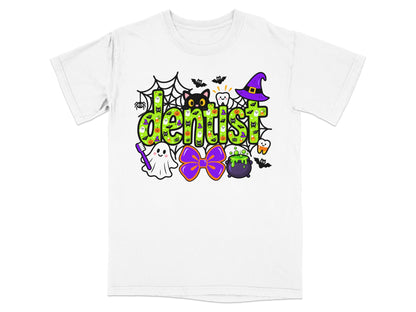 A white short-sleeved t-shirt features a colorful Halloween themed graphic that reads dentist in green letters.