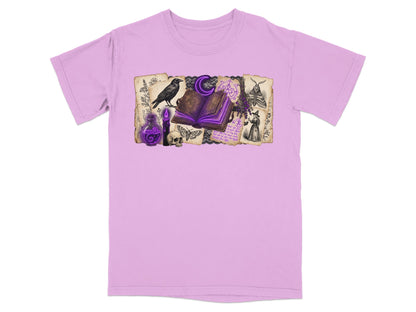Lilac t-shirt with a witchy graphic featuring a crow, open book, potion, skull, and moths.