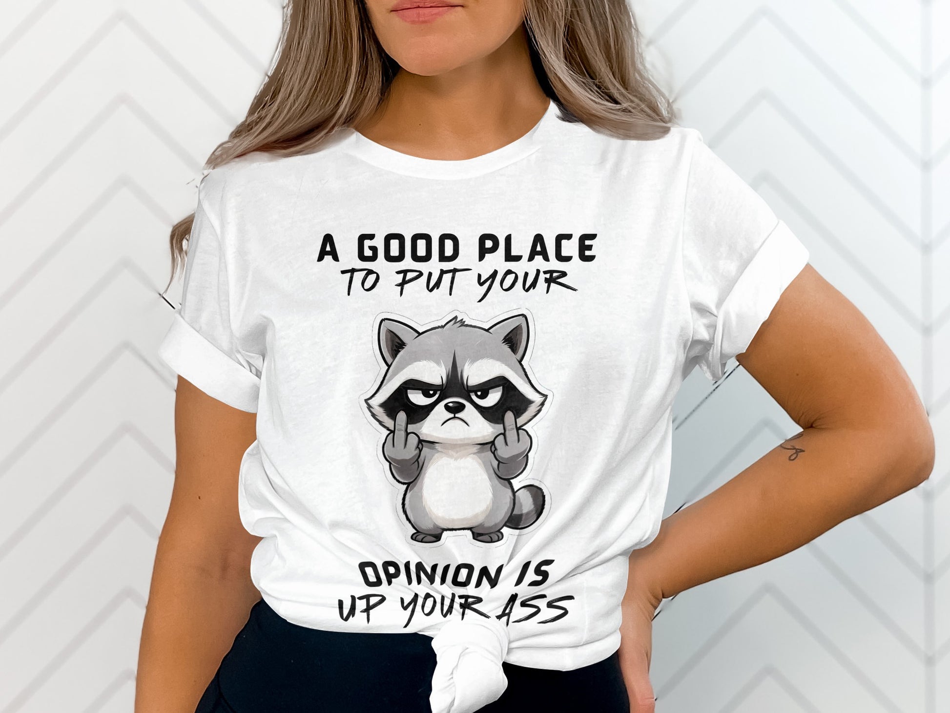 White t-shirt with a grumpy raccoon giving the middle finger and text.