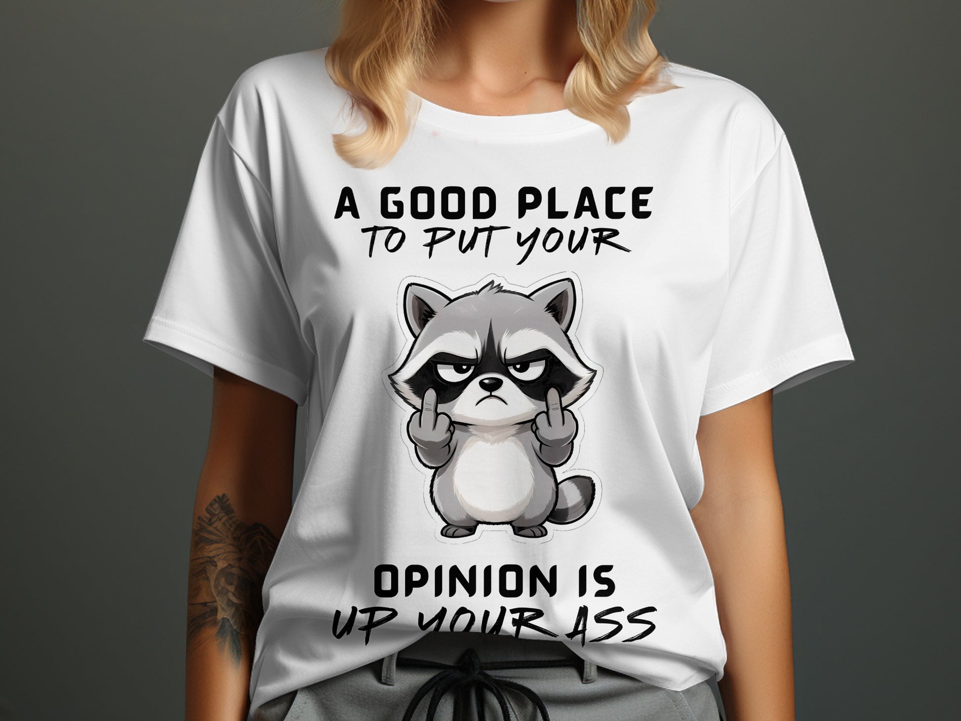 White t-shirt with graphic of a raccoon giving middle fingers and text "A good place to put your opinion is up your ass".
