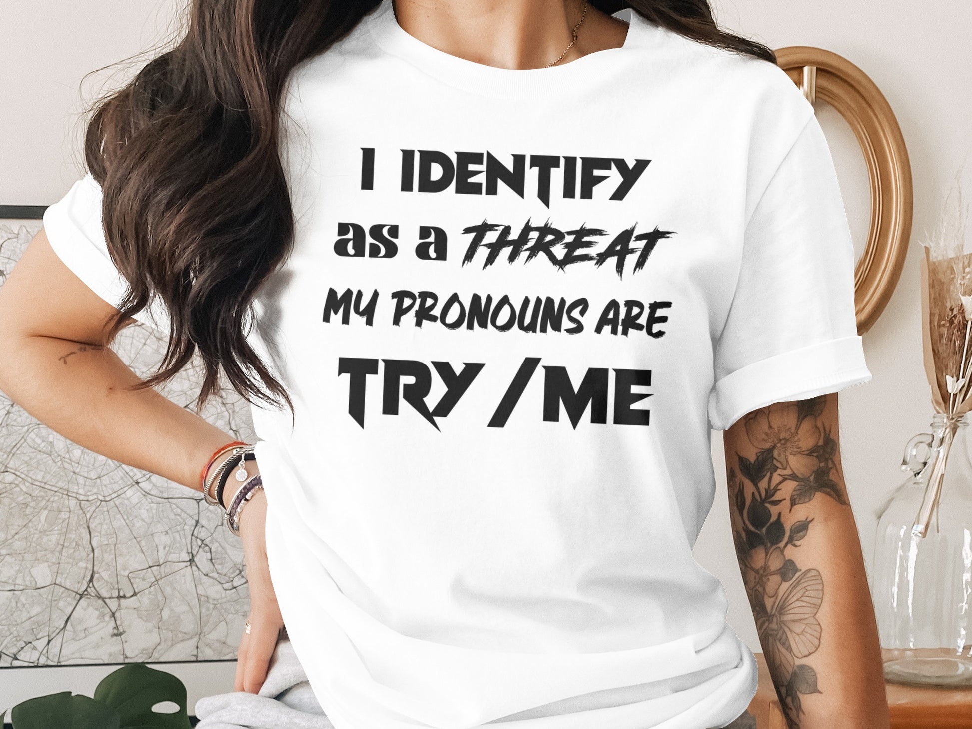 White t-shirt with black text: "I IDENTIFY as a THREAT MY PRONOUNS ARE TRY / ME"