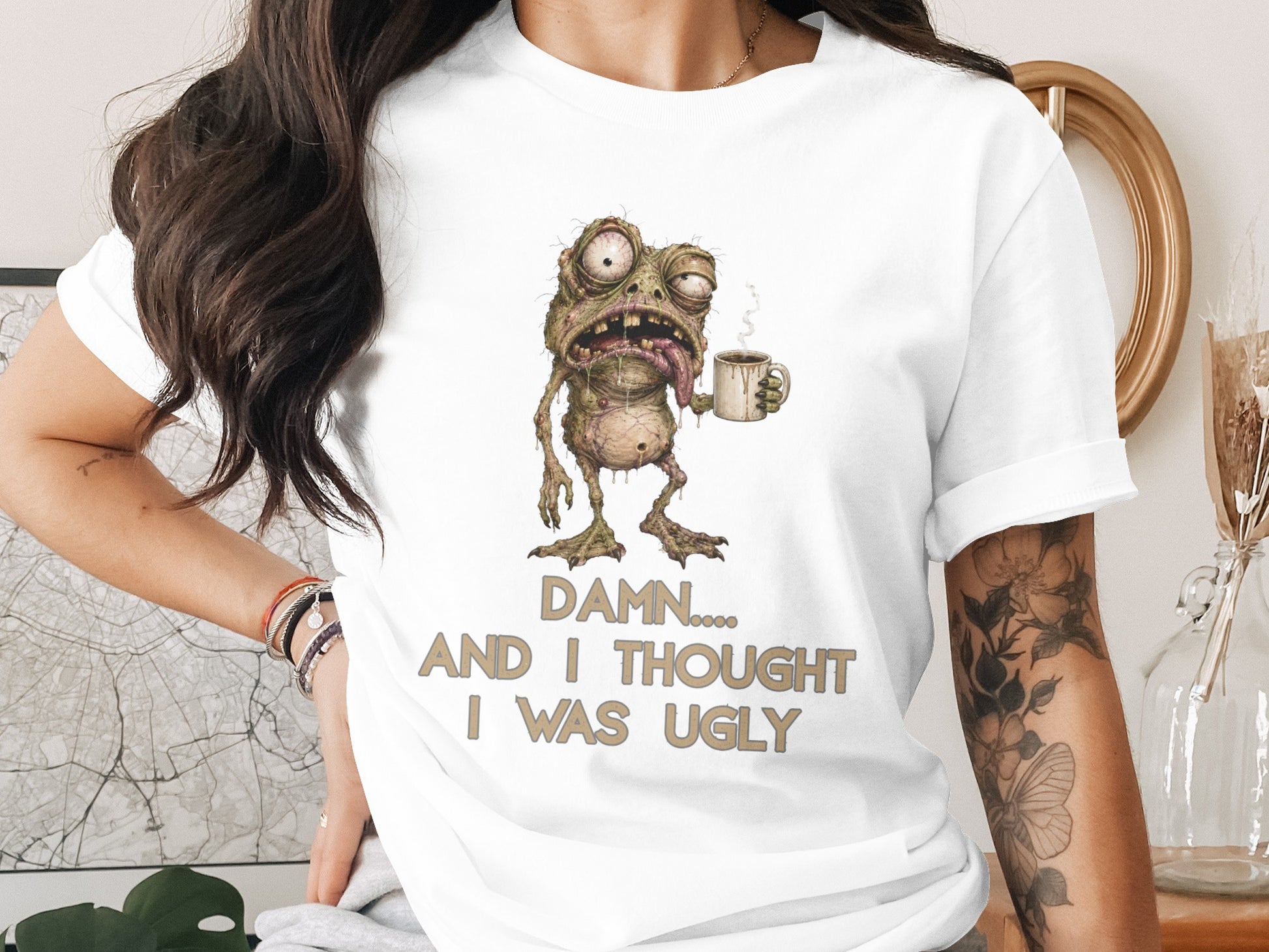 T-shirt with a cartoon monster holding coffee, reading "DAMN.... AND I THOUGHT I WAS UGLY".