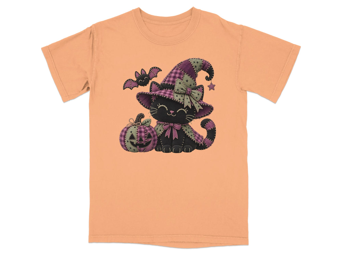 Orange t-shirt with a black cat wearing a patchwork witch hat and bow tie.