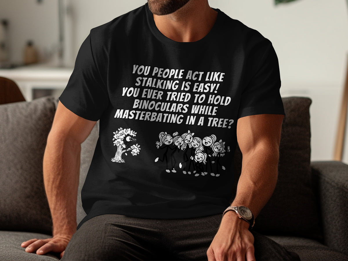 Black t-shirt with text and cartoon image of stick figures in a tree.