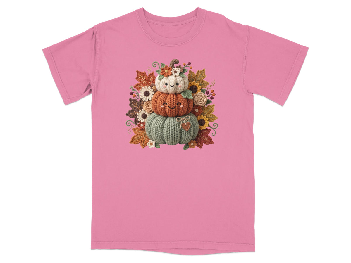 Stack of three smiling pumpkins with autumn leaves and flowers.