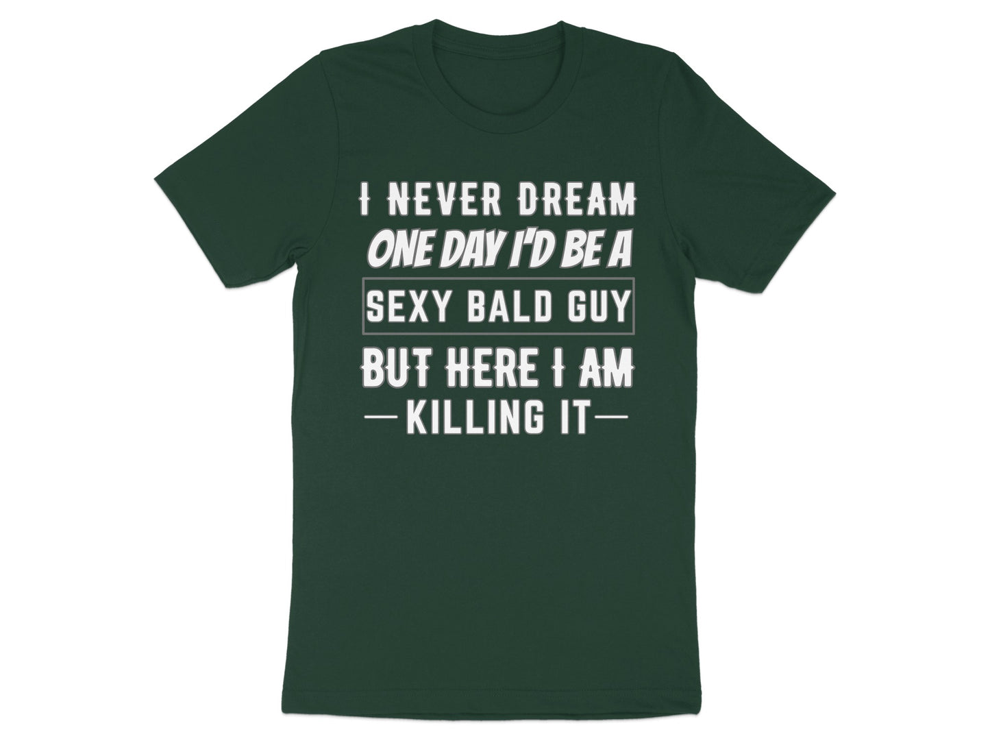 Dark green t-shirt with white text reading "I NEVER DREAM ONE DAY I'D BE A SEXY BALD GUY BUT HERE I AM -KILLING IT—".