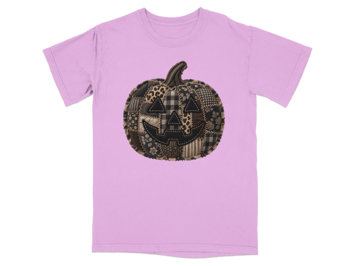 Pink t-shirt with a patchwork jack-o'-lantern design.