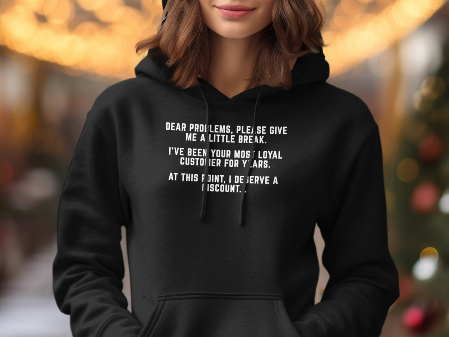 Black hoodie with white text: "Dear problems, please give me a little break. I've been your most loyal customer for years. At this point, I deserve a discount."