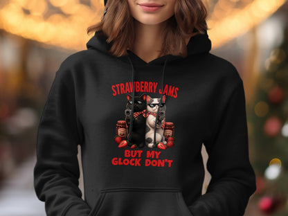 Black hoodie with "Strawberry Jams But My Glock Don't" text and cats with guns.