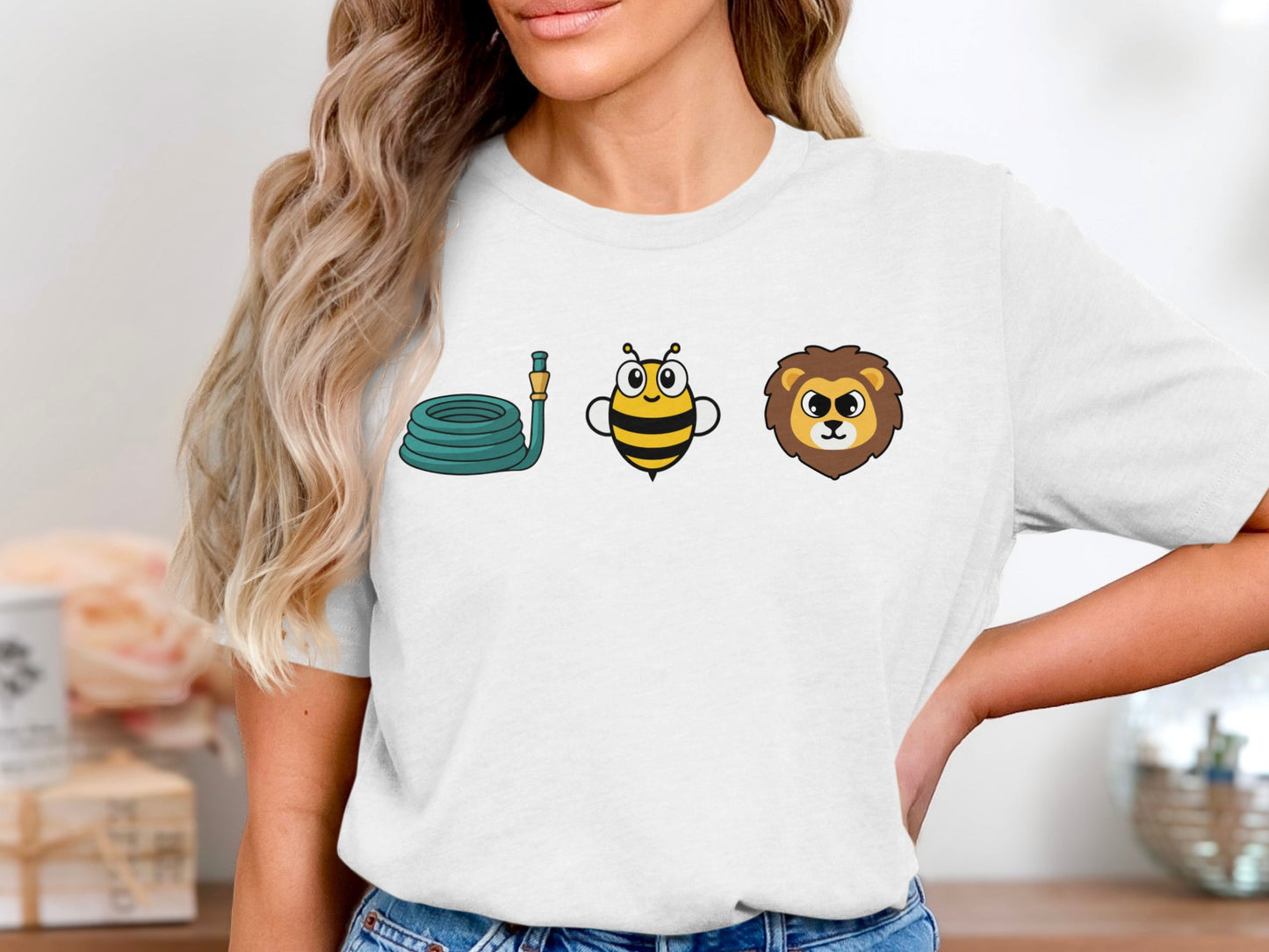 T-shirt graphic with coiled hose, cartoon bee, and lion head icons.