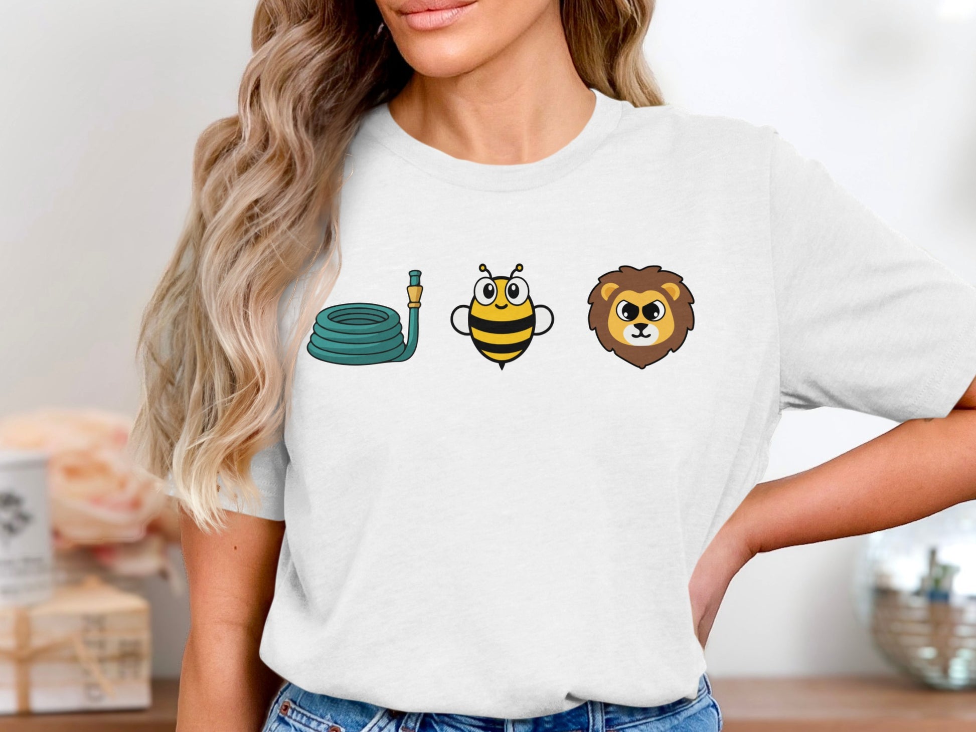 T-shirt graphic with coiled hose, cartoon bee, and lion head icons.