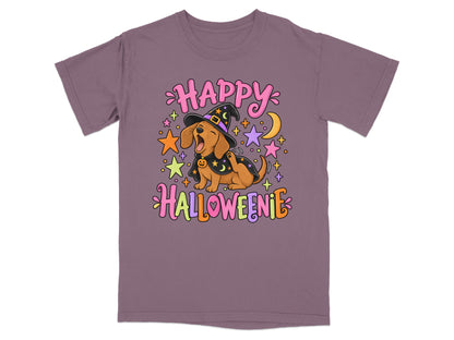 Dachshund in witch hat with "Happy Halloweenie" text, surrounded by stars and moon.