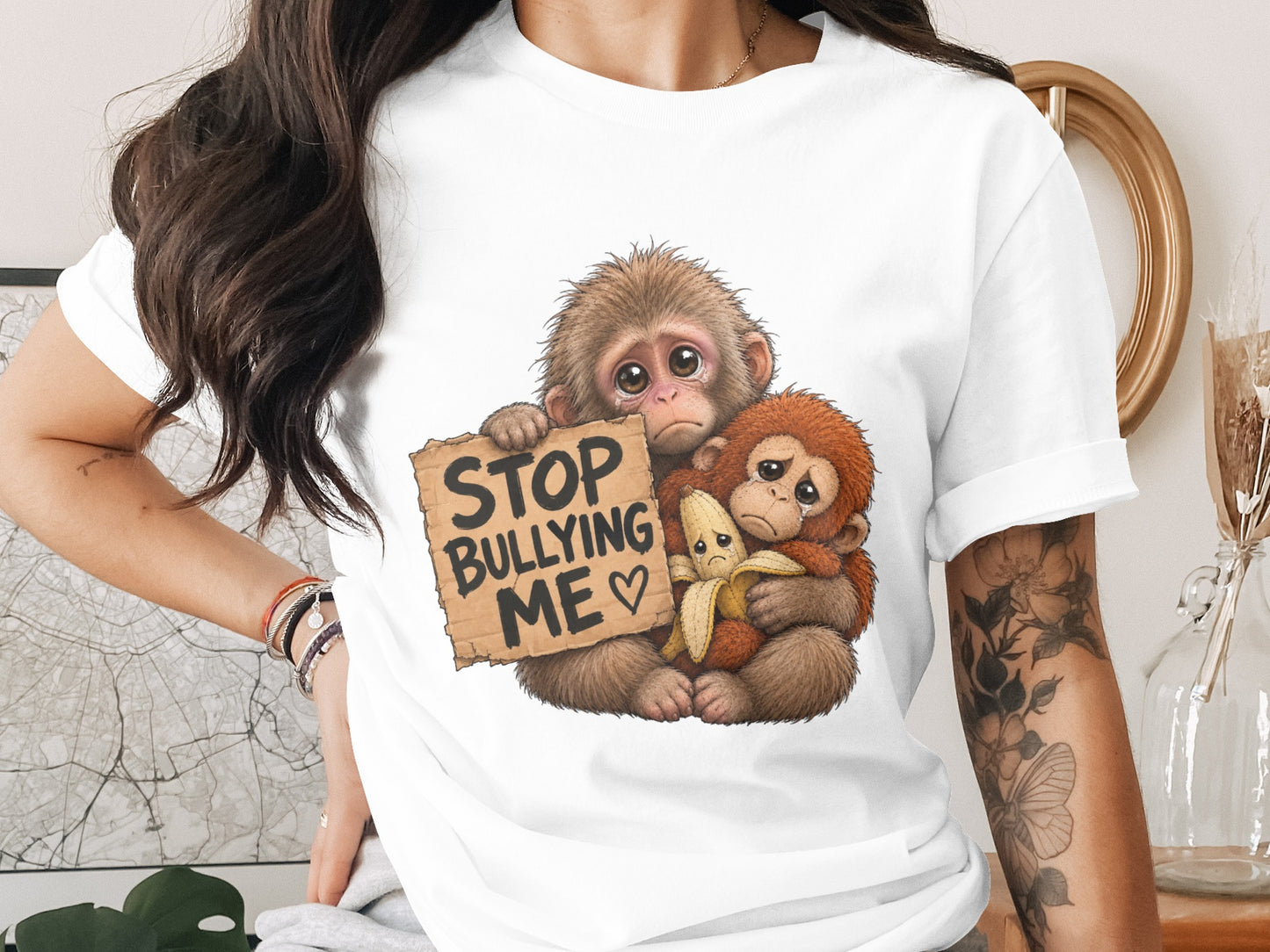 Two sad monkeys, one holding a "Stop Bullying Me" sign and a banana.