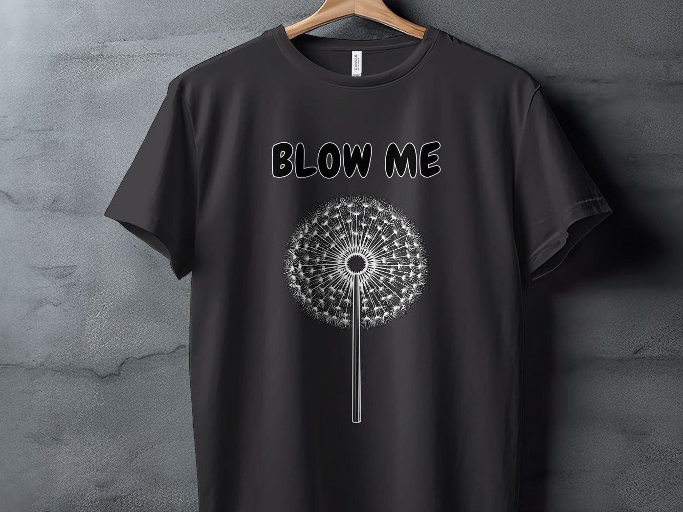 Black t-shirt with white text "BLOW ME" and dandelion graphic.