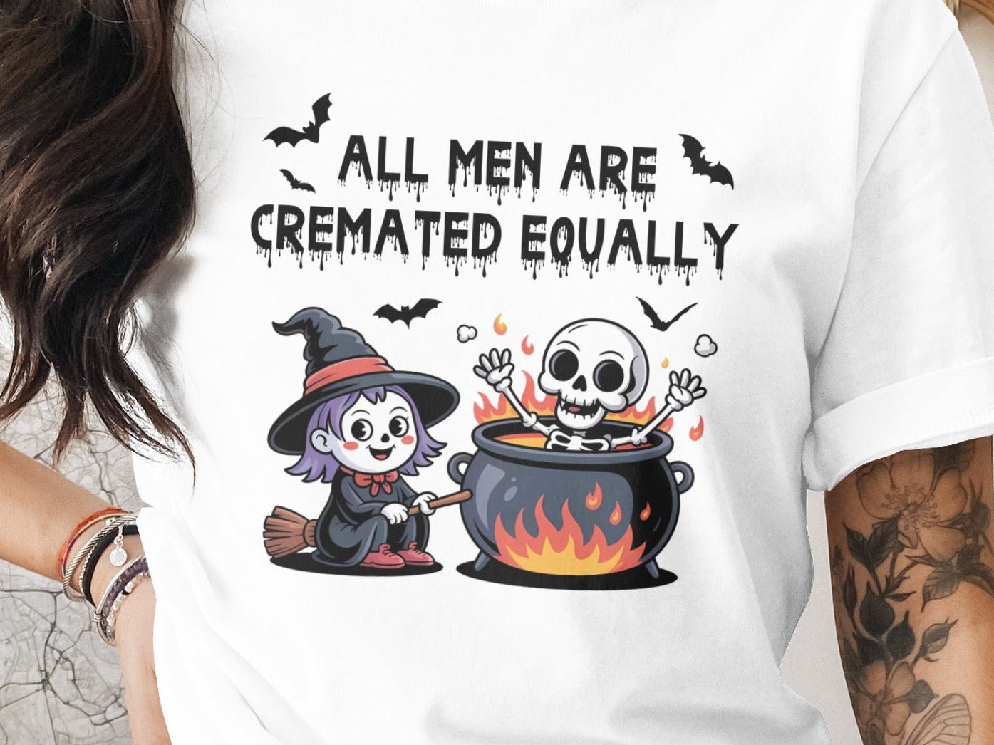 White t-shirt with Halloween design and text "ALL MEN ARE CREMATED EQUALLY".