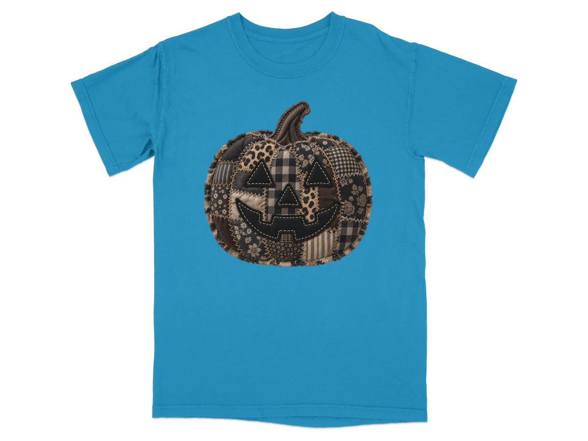Blue t-shirt with a patchwork pumpkin graphic.