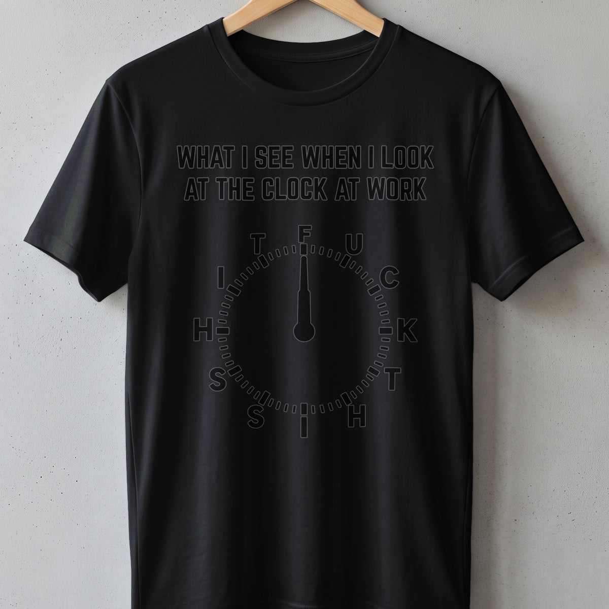 Black t-shirt with text "WHAT I SEE WHEN I LOOK AT THE CLOCK AT WORK" and a clock graphic.