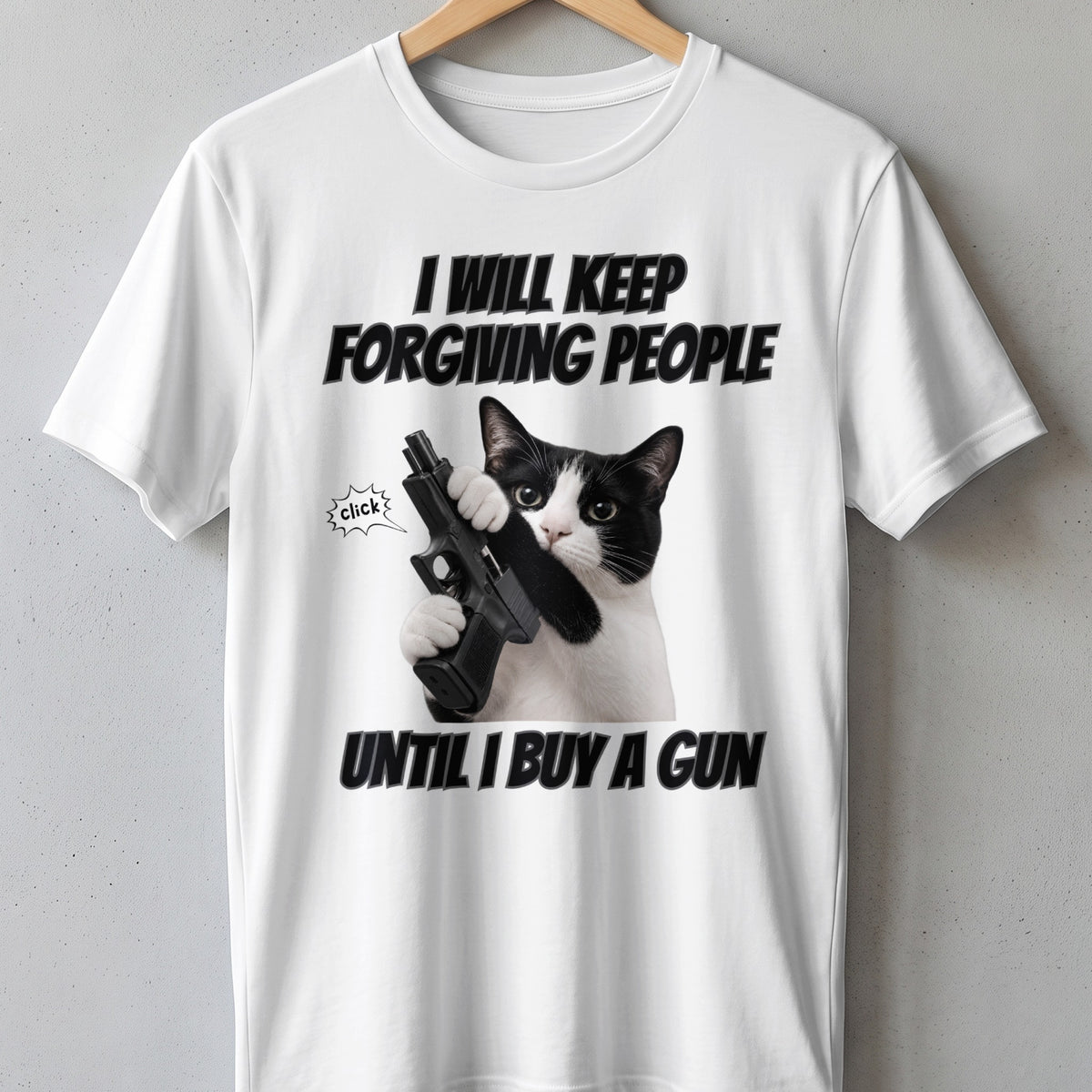 White t-shirt with black text "I WILL KEEP FORGIVING PEOPLE UNTIL I BUY A GUN" and a cat holding a gun.