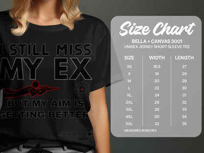 Black t-shirt with "I still miss my ex but my aim is getting better" text and size chart.