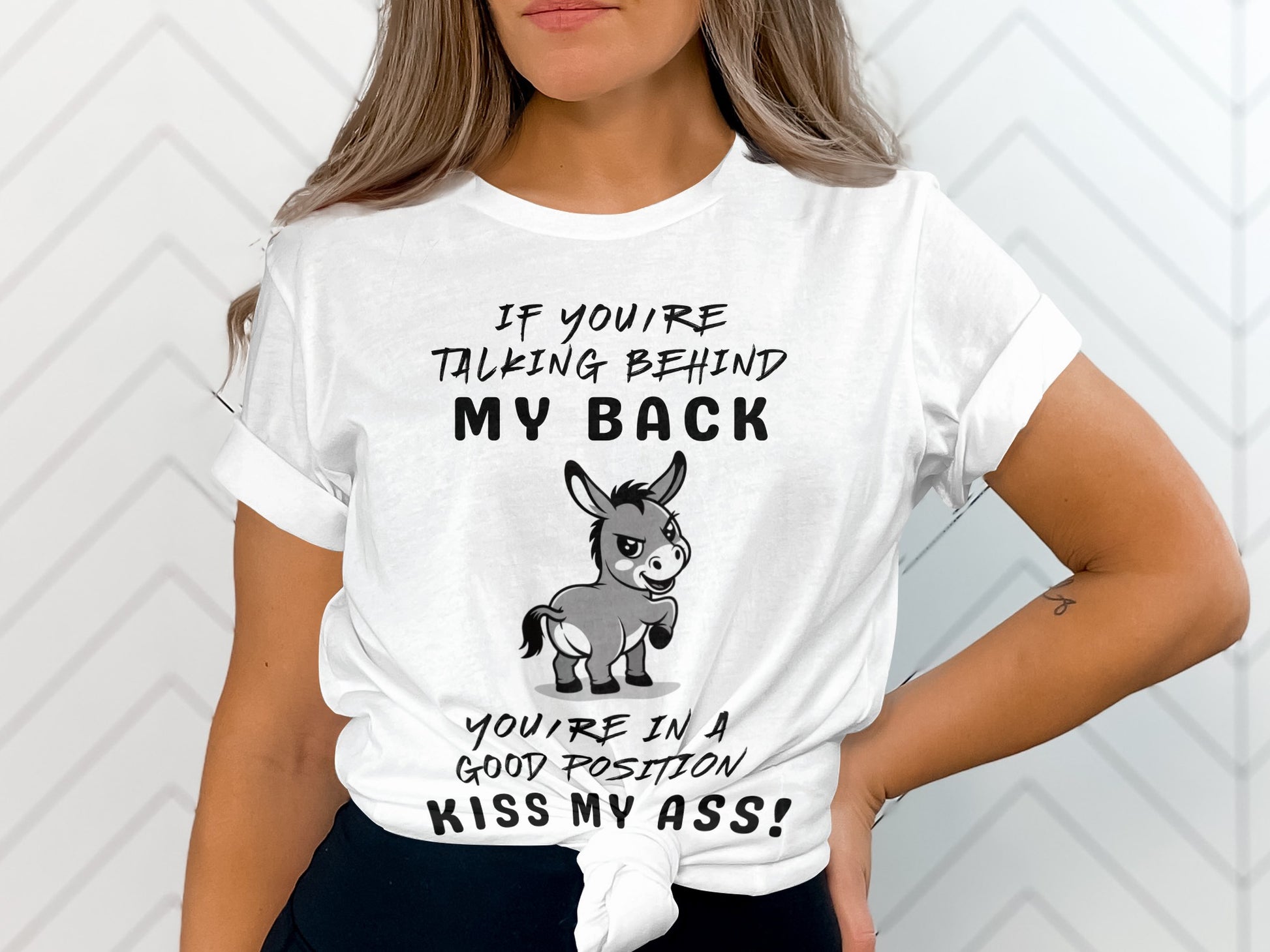 White t-shirt with text "If you're talking behind my back, you're in a good position, kiss my ass!" and a donkey illustration.