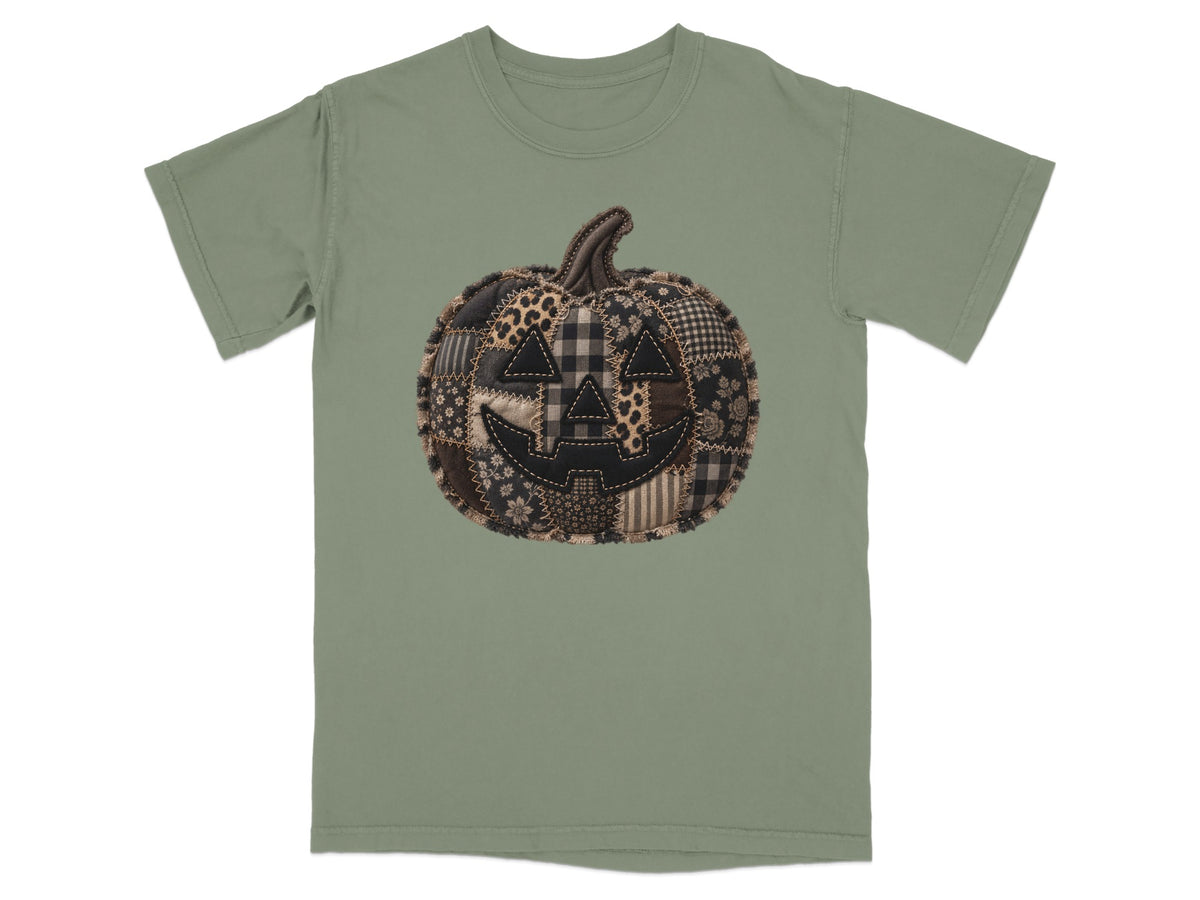Green t-shirt with a patchwork quilted jack-o'-lantern graphic.