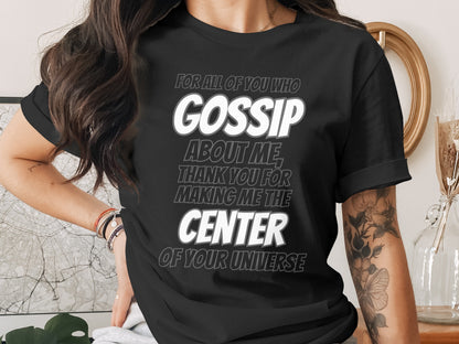 Black t-shirt with "GOSSIP ABOUT ME THANK YOU FOR MAKING ME THE CENTER OF YOUR UNIVERSE" text.