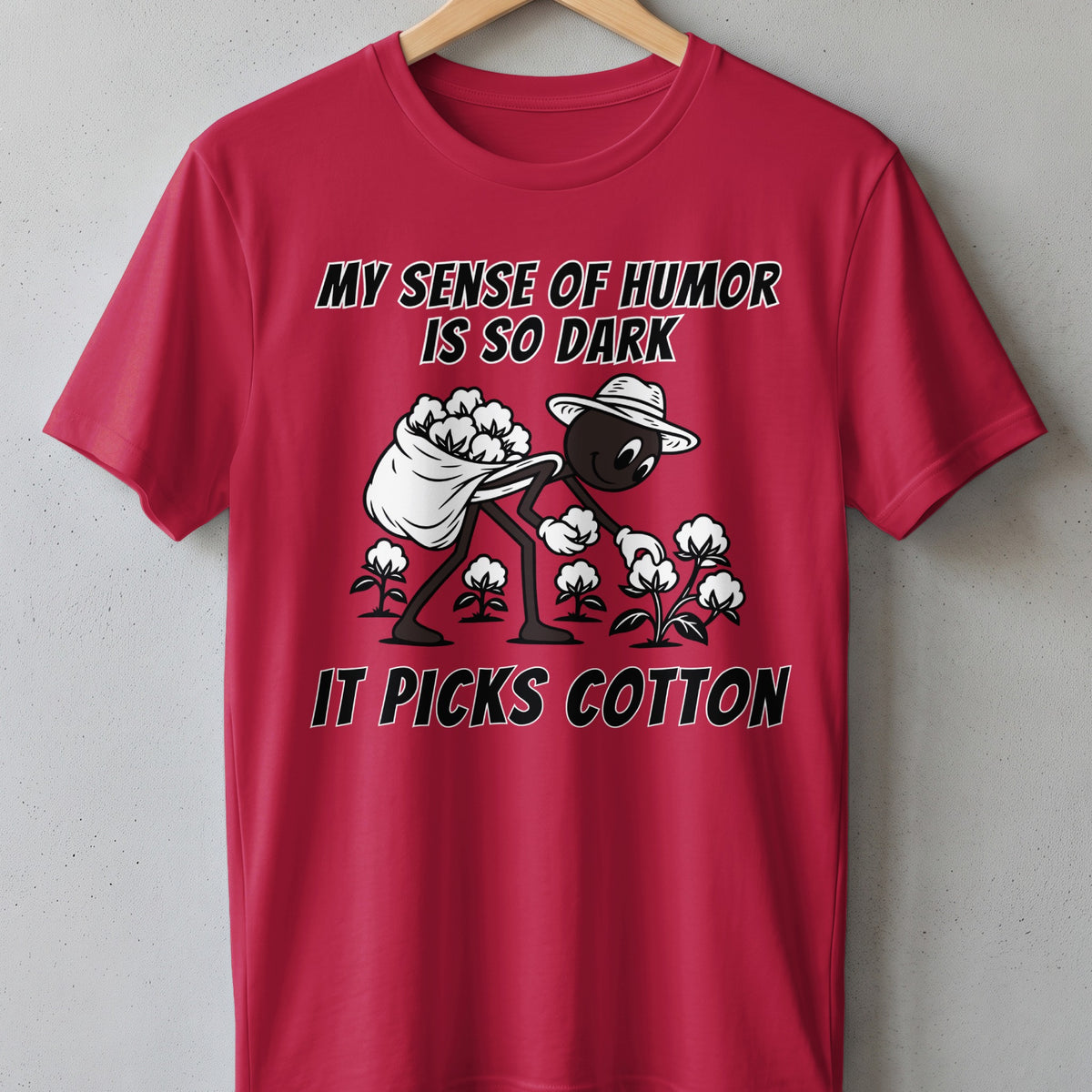 Red t-shirt with cartoon character picking cotton, text reads "My sense of humor is so dark it picks cotton."