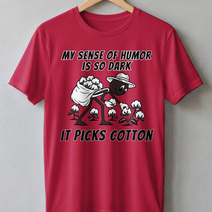 Red t-shirt with cartoon character picking cotton, text reads "My sense of humor is so dark it picks cotton."