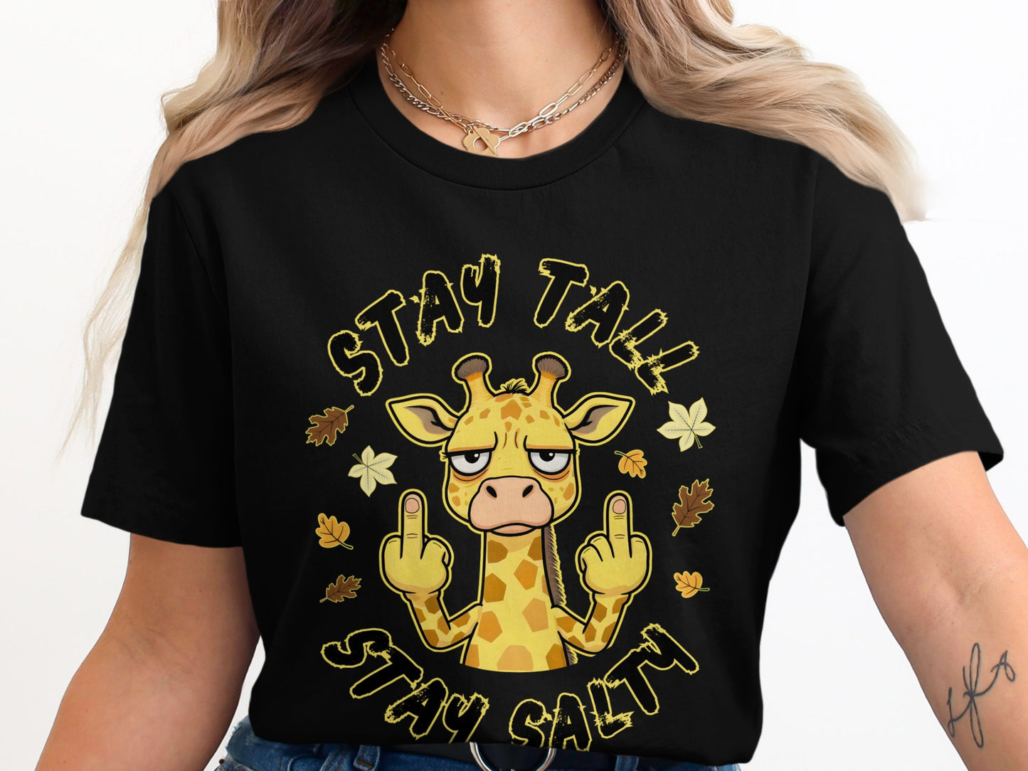Black t-shirt with cartoon giraffe giving middle fingers, surrounded by leaves, text "STAY TALL STAY SALTY".