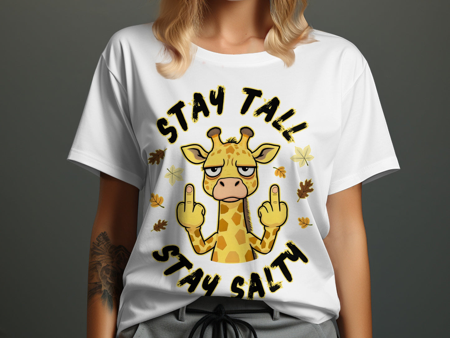White t-shirt with a cartoon giraffe giving the middle finger, text says "STAY TALL STAY SALTY".