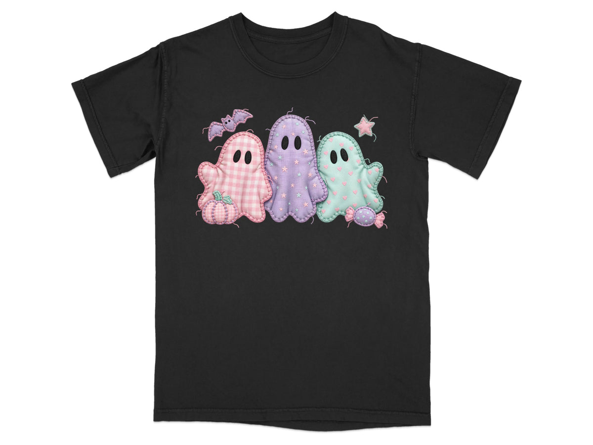 Black t-shirt featuring three pastel ghosts, a pumpkin, bat, star, and candy.