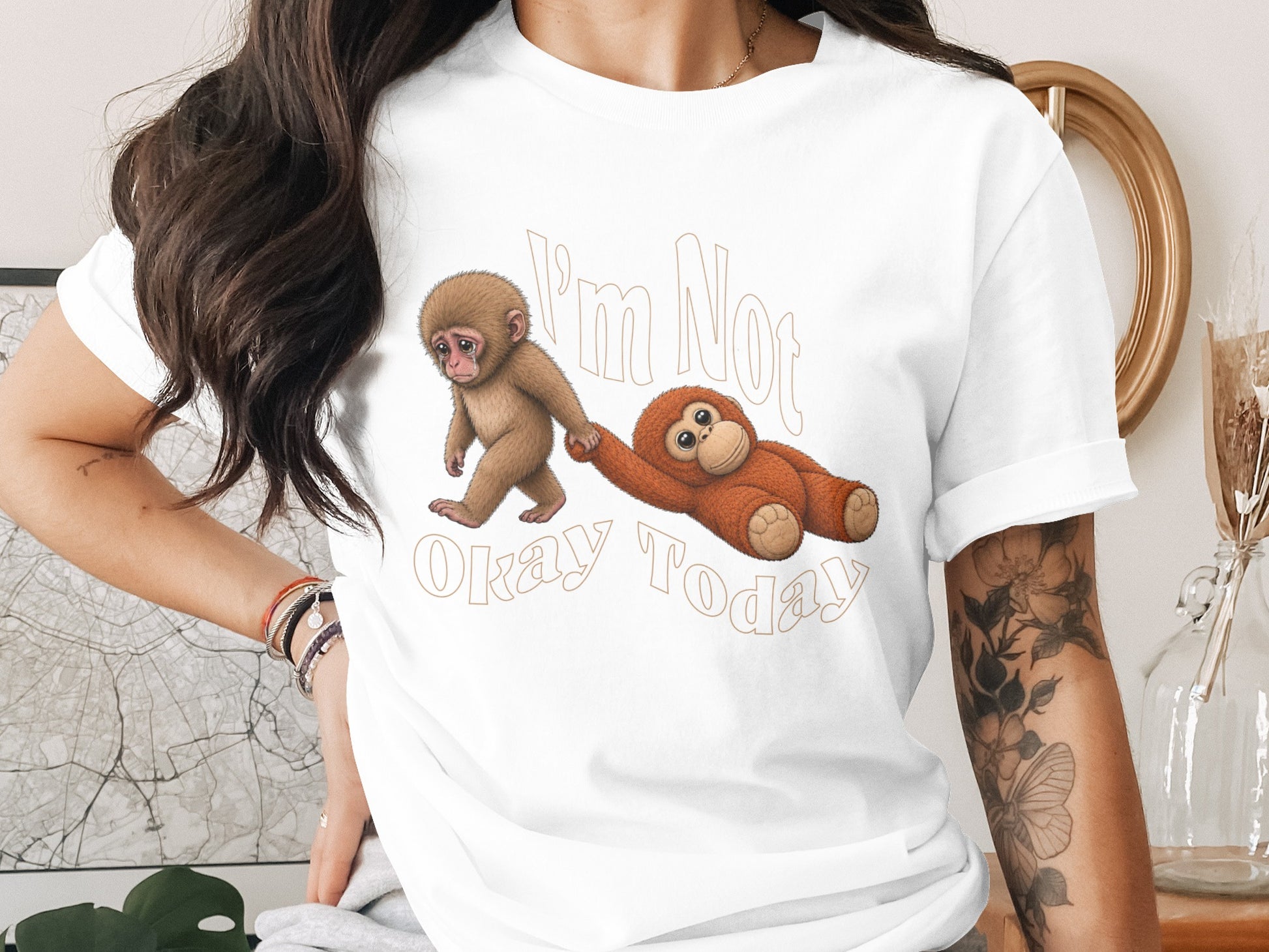 White t-shirt with brown monkeys graphic and text "I'm Not Okay Today".