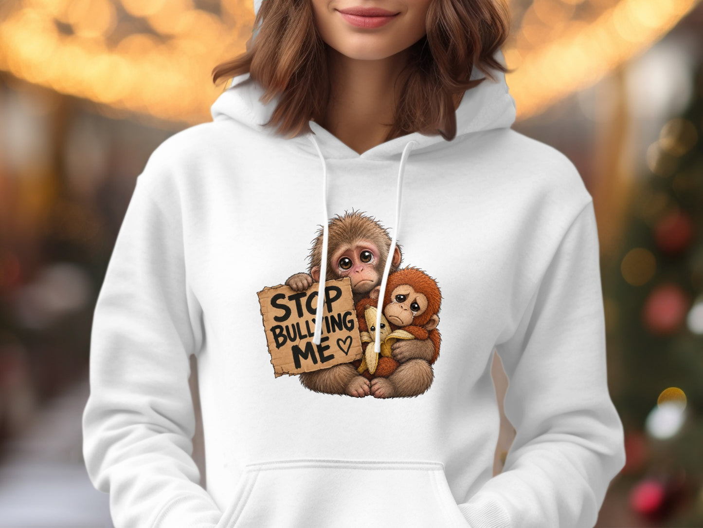 Two cartoon monkeys with sad eyes, one holding a banana and a sign reading "STOP BULLYING ME."